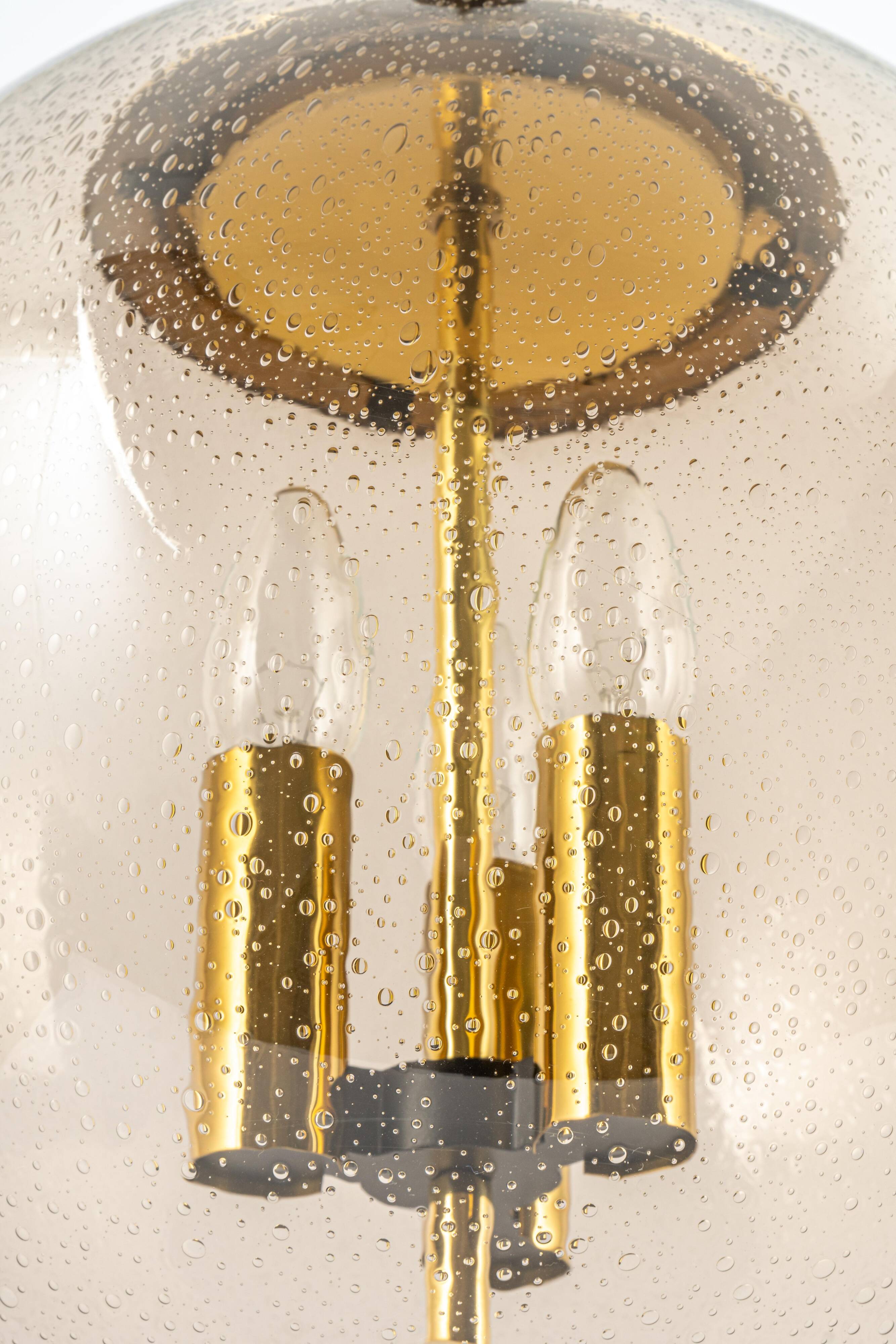 Large Limburg pendant light in brass with smoked glass ball, Germany, 1970s.