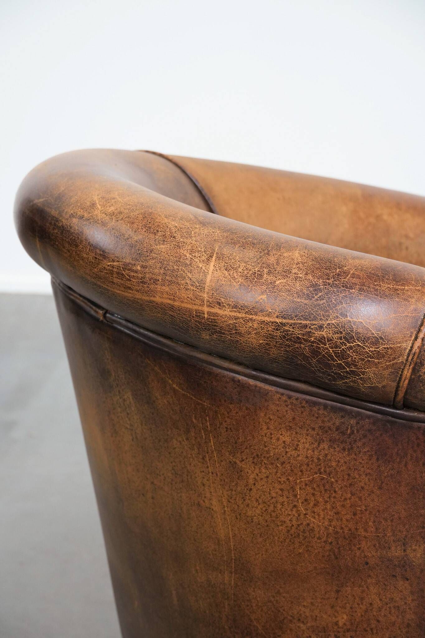Vintage club chair in sheepskin leather with a characterful look