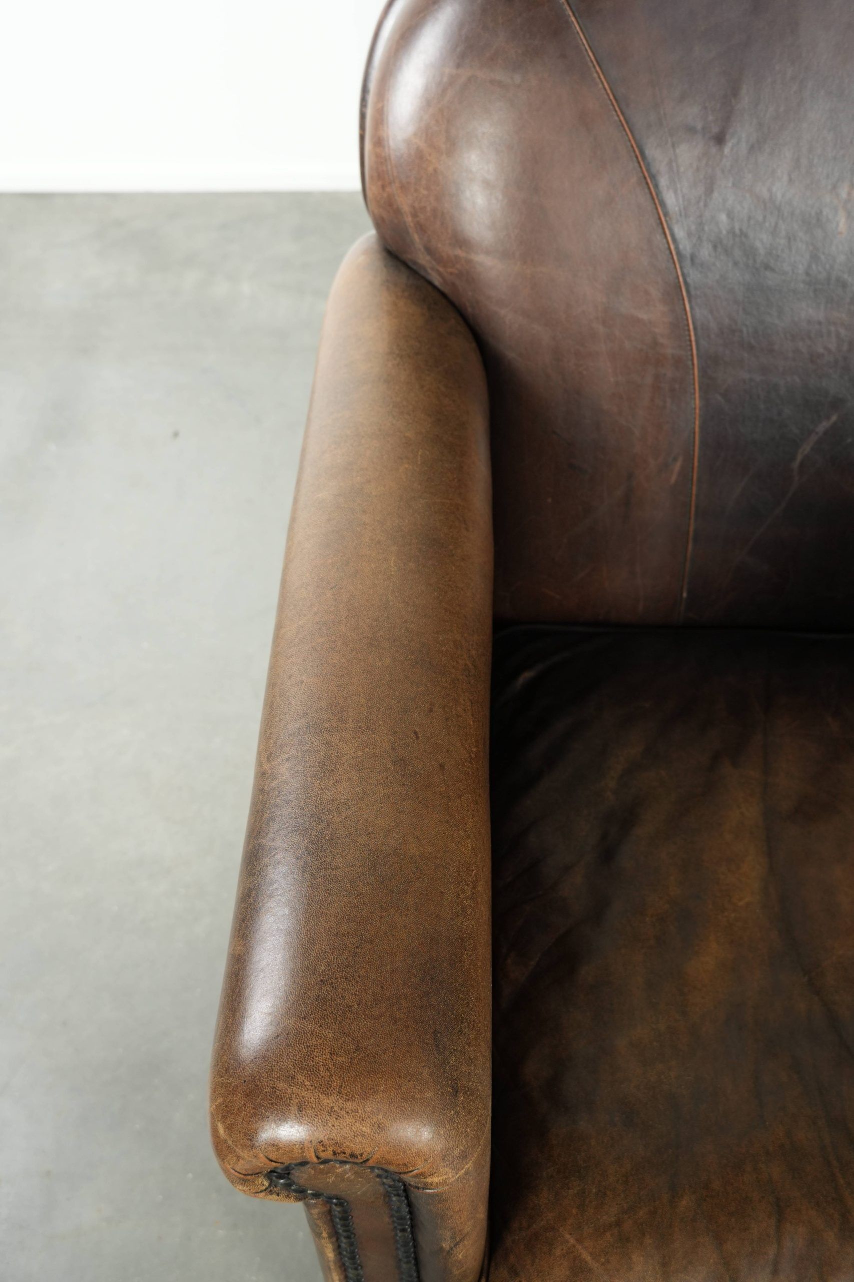 Characterful sheepskin design armchair with beautiful patina