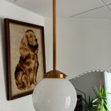 Opaline white globe pendant light with metal stem, Art Deco style.