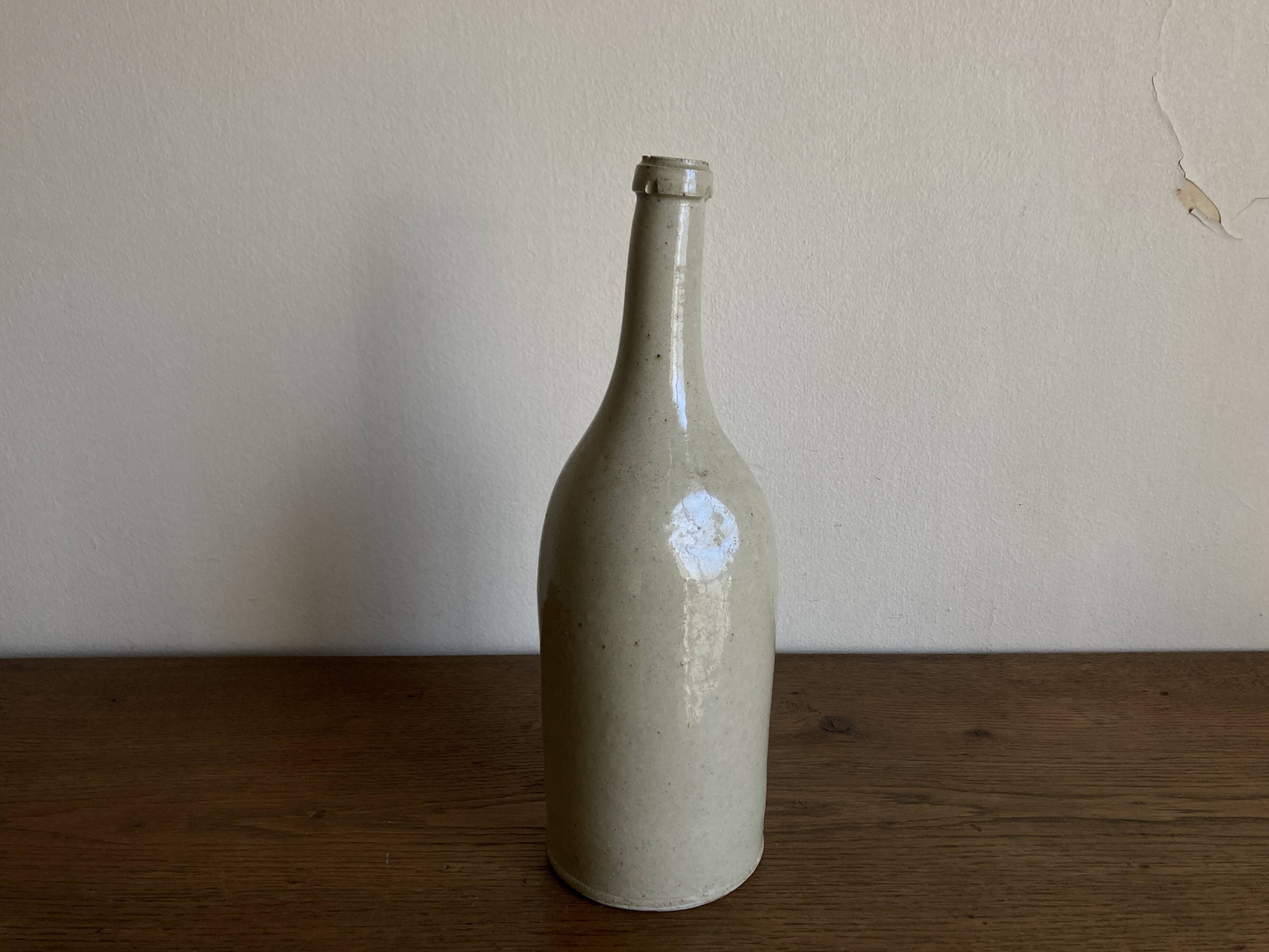 Stoneware bottle tilted at an angle, early 20th century