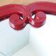 Oval mirror, red enamelled metal in Art Deco style, 49 x 39 cm.