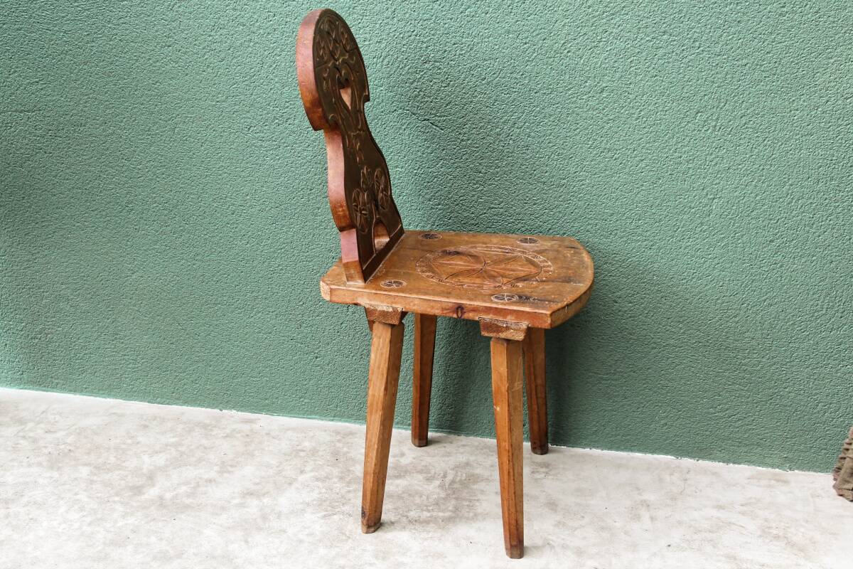 Old Swiss escabelle chair in carved wood
