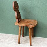 Old Swiss escabelle chair in carved wood