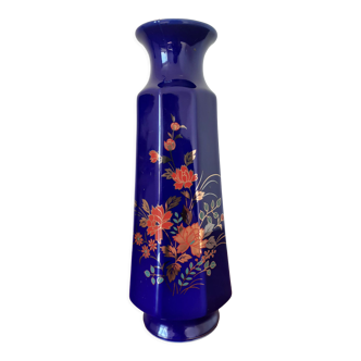 Blue vase with orange and green flowers