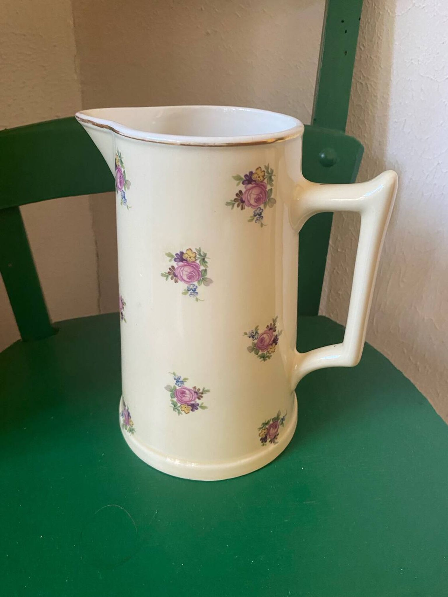 Old flowery and gilded pitcher.