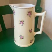 Old flowery and gilded pitcher.
