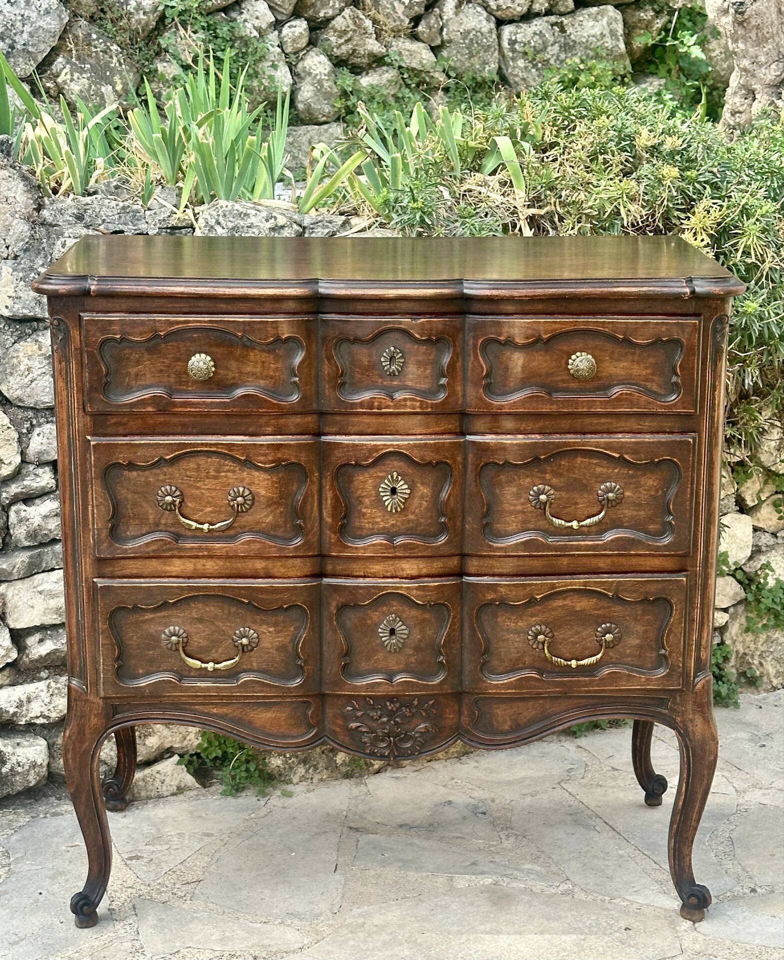 Carved and moulded solid wood commode in the Louis XV style.