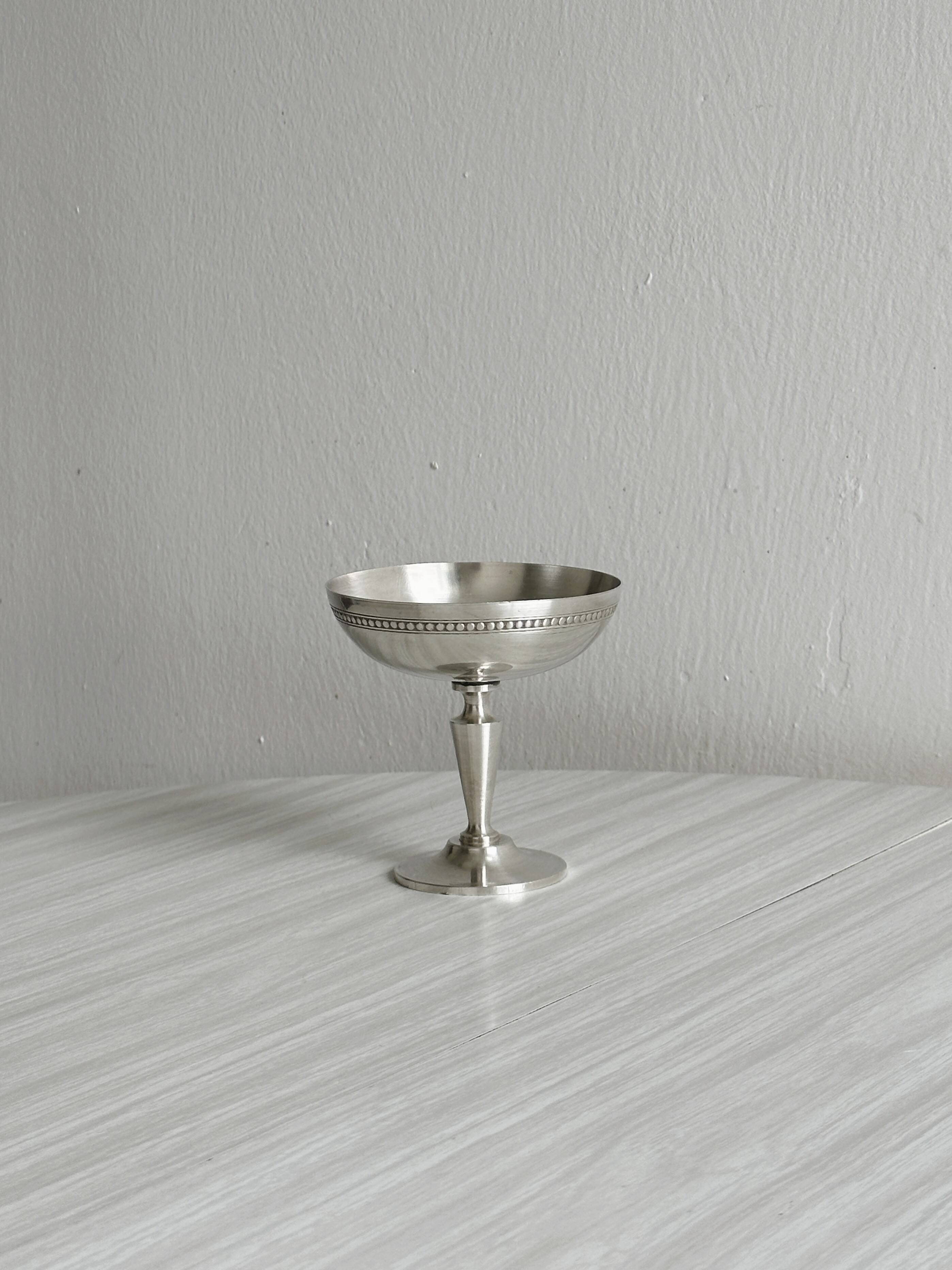 Silver-plated metal bowl on a stand