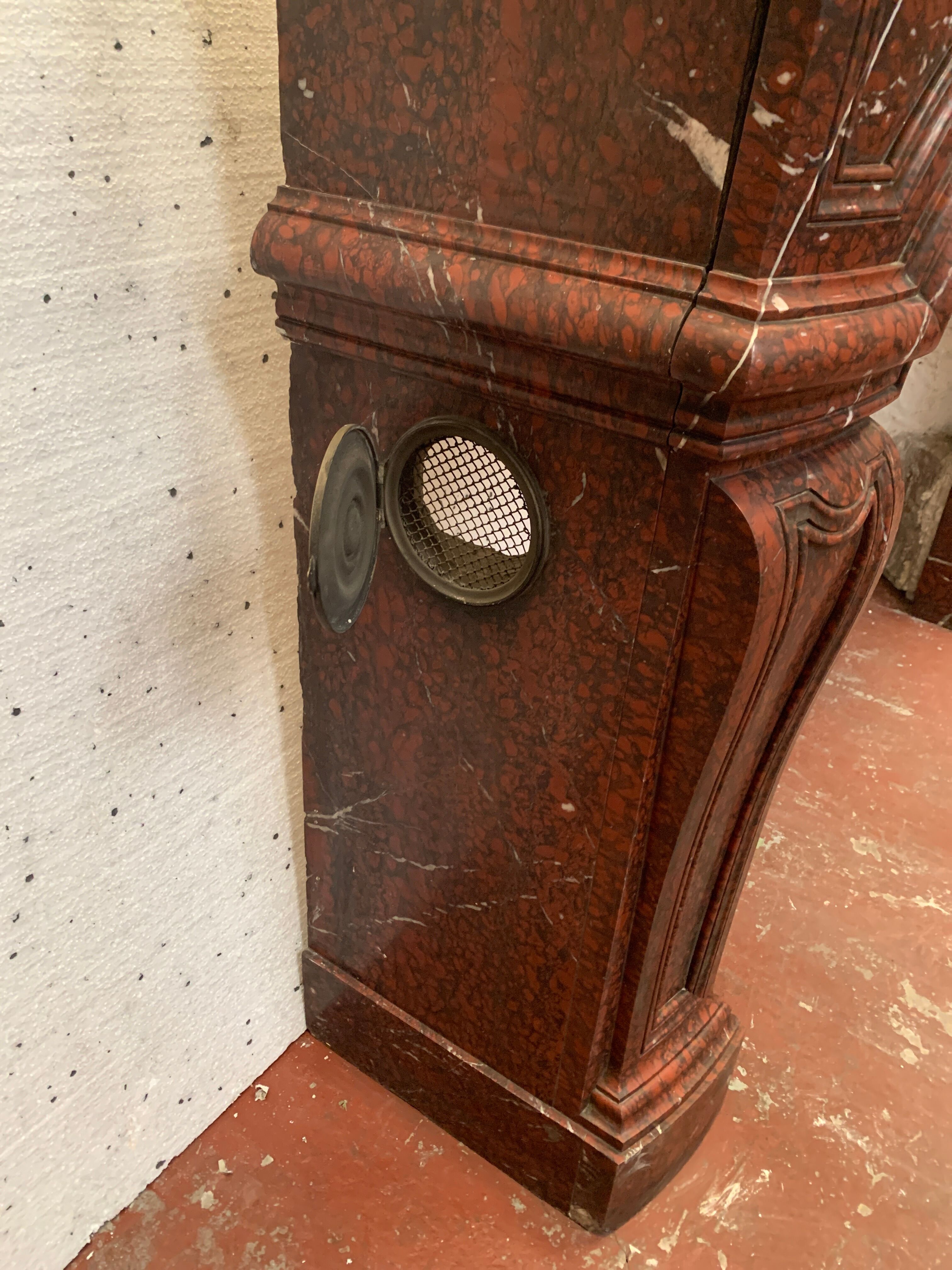 Pair of Louis XIV style fireplaces in red cherry marble. XIX century.