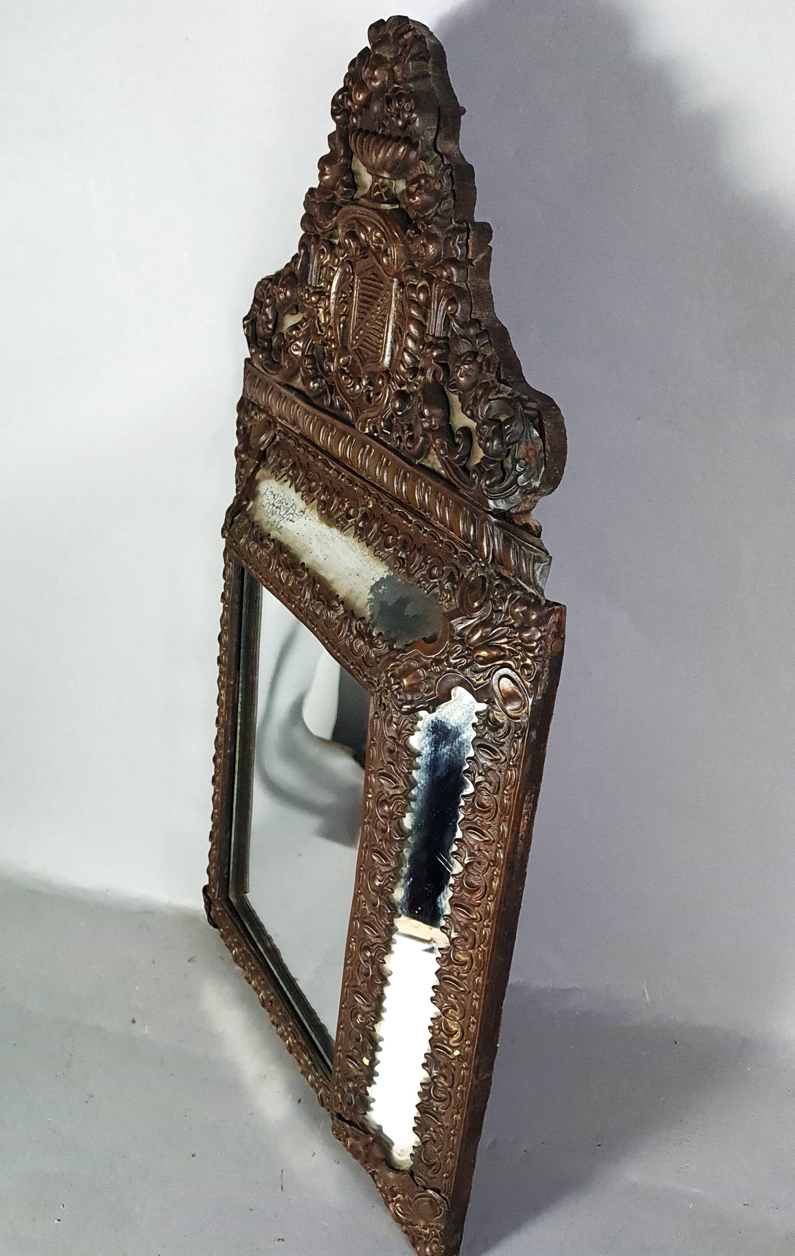 Antique brass repoussé mirror with wooden backing, 59x31 cm, C831.