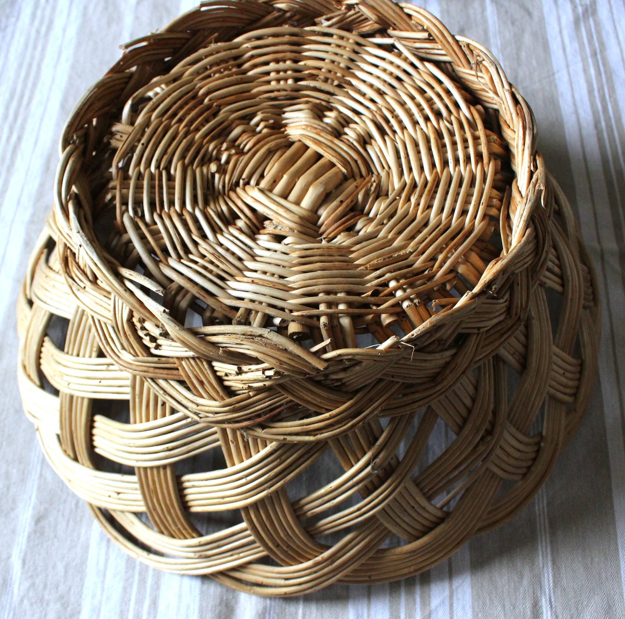 Large vintage twisted wicker basket on a stand