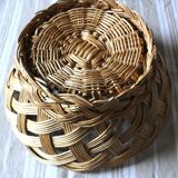 Large vintage twisted wicker basket on a stand