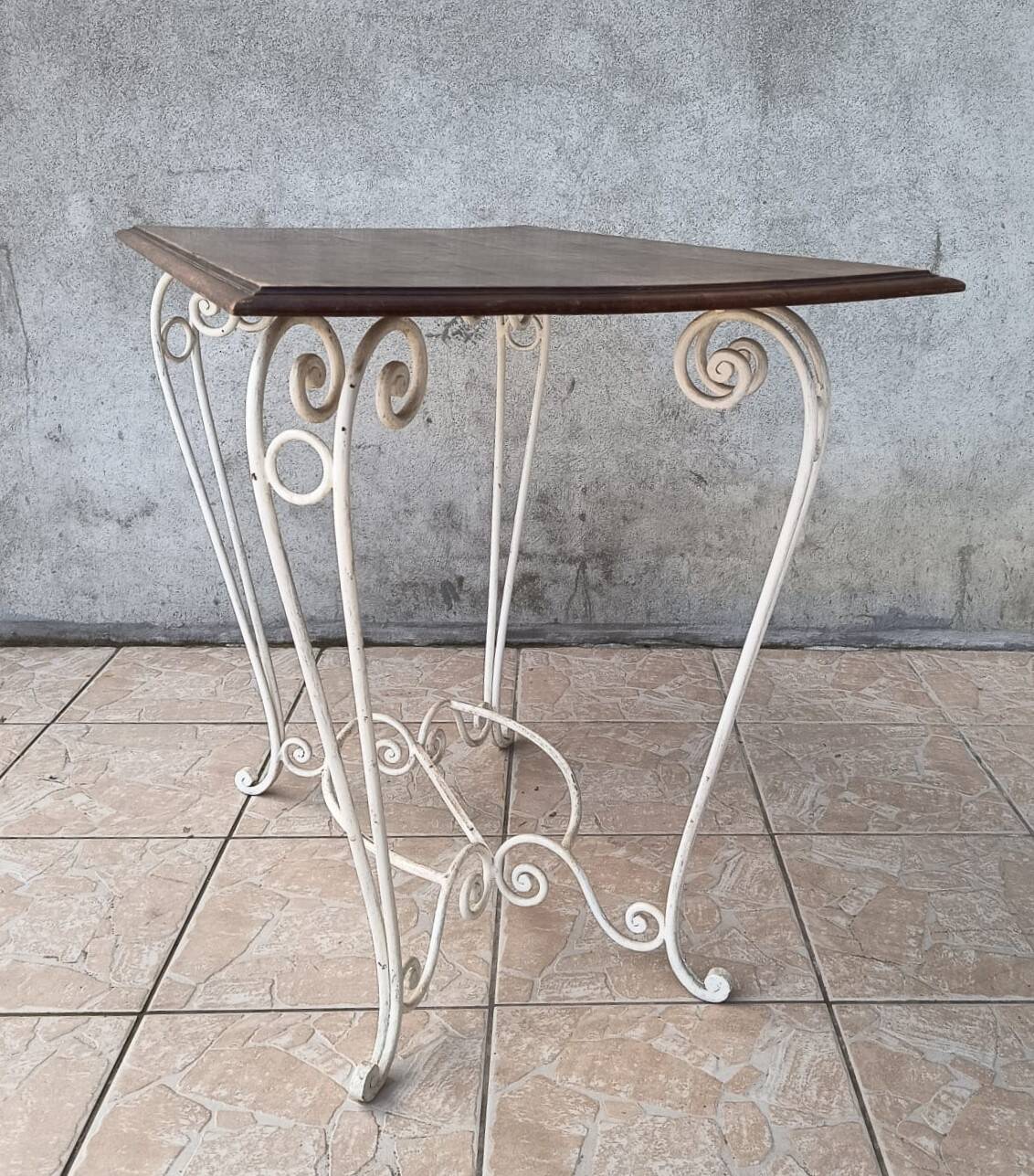Wrought iron table with a walnut top.