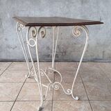 Wrought iron table with a walnut top.