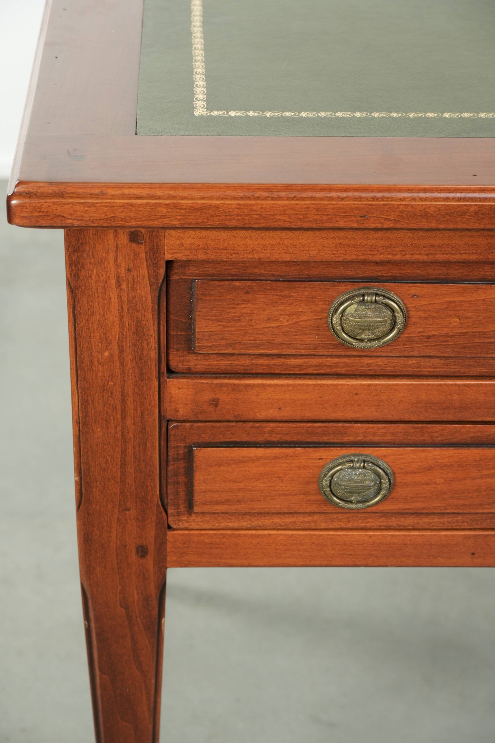 Elegant English style desk with green leather top, gold details and drawers
