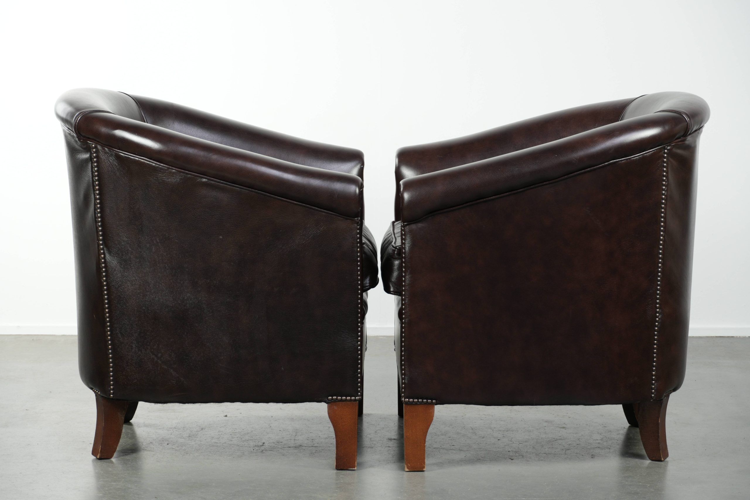Set of two cowhide club armchairs in good condition with a English design