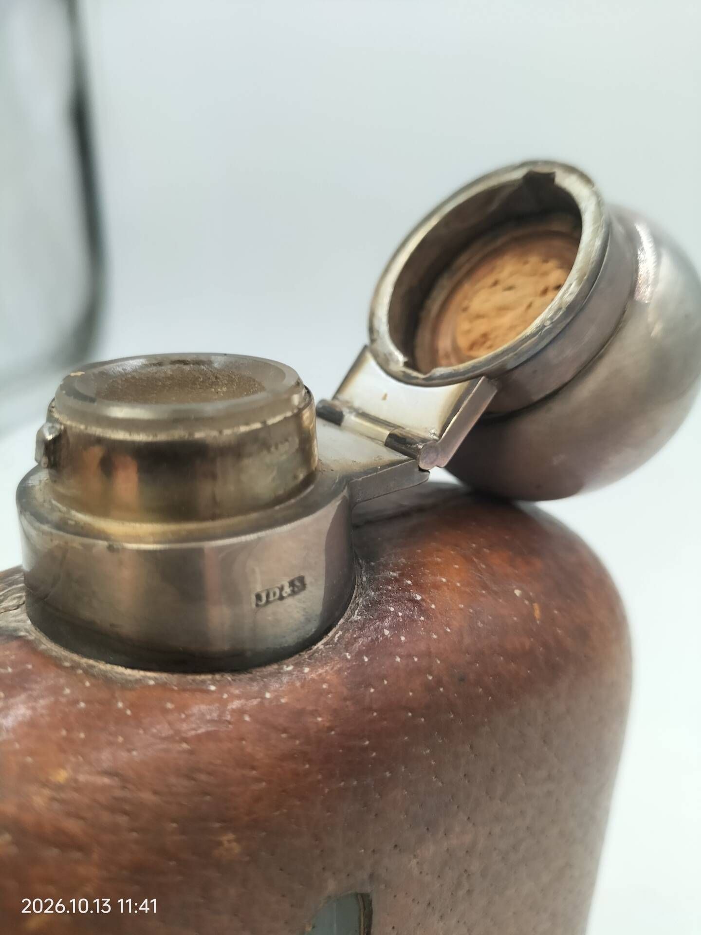 Silver-plated metal flask with leather and glass