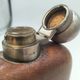 Silver-plated metal flask with leather and glass