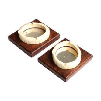 Pair of wooden ashtrays and bakelite, mirrored backgrounds, 30s