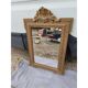 19th-century mirror in gilded wood and stucco.