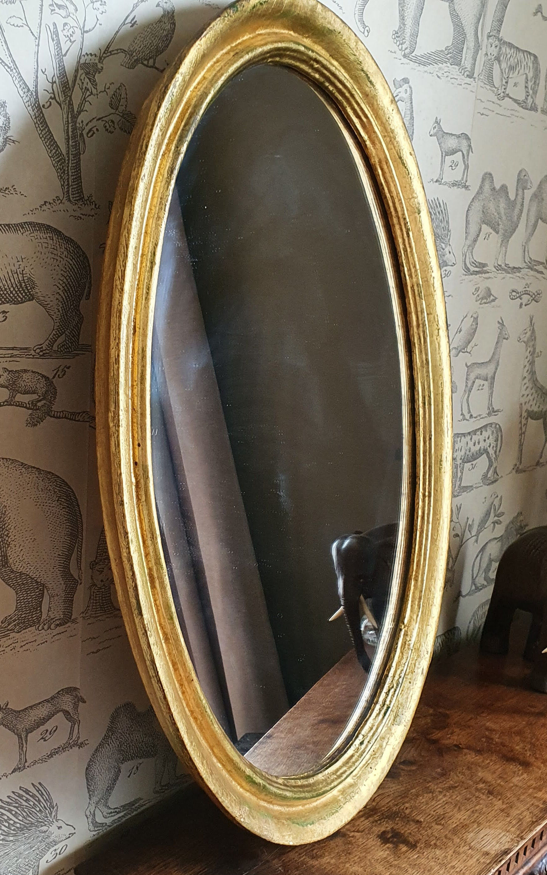 Oval mirror in gilded wood 67X52