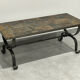 Brutalist-style coffee table made of mixed wrought iron and stone.