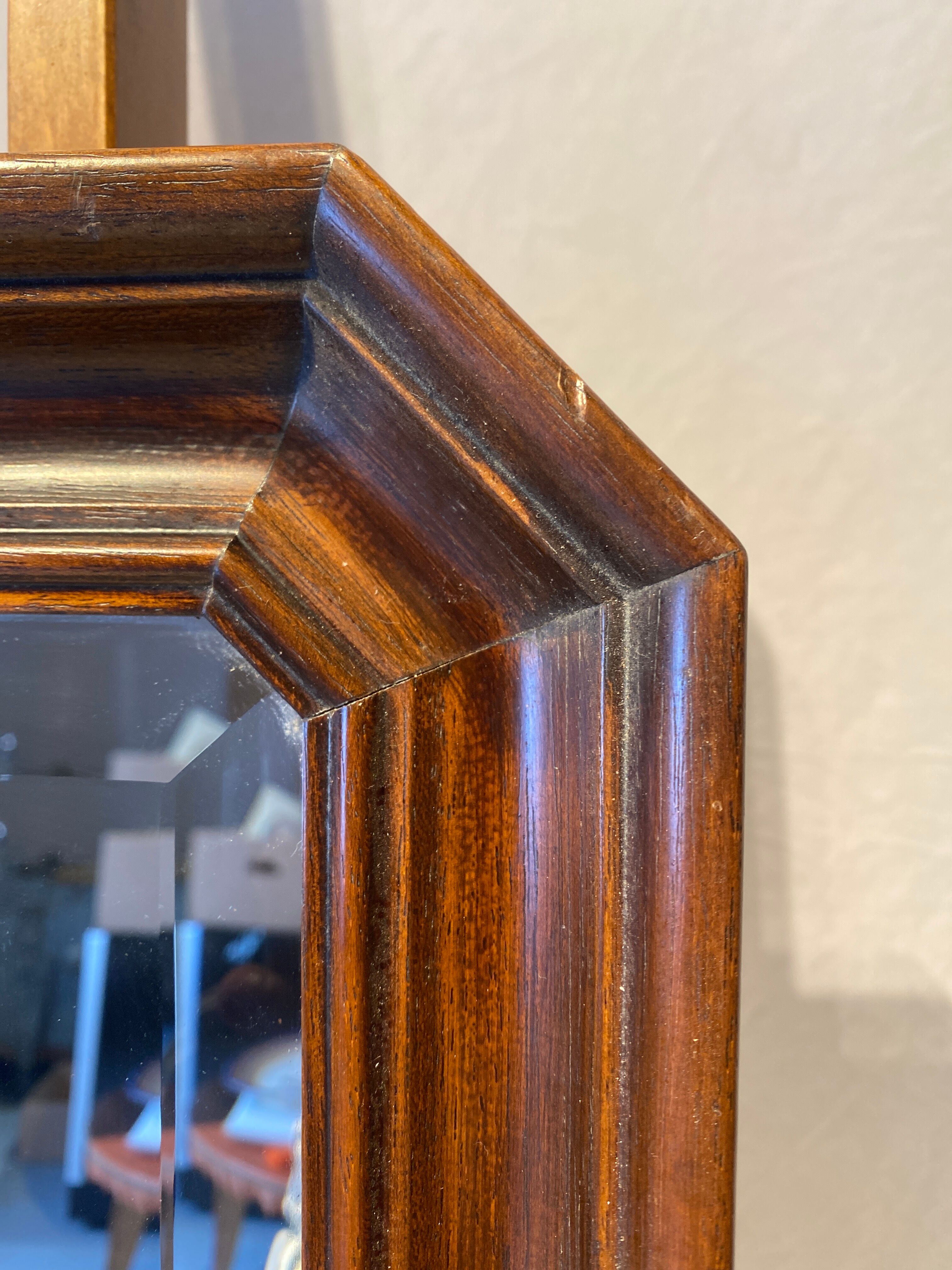 Beveled mirror in its wooden frame