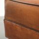 Handy sheepskin ottoman with warm colours finished with black piping