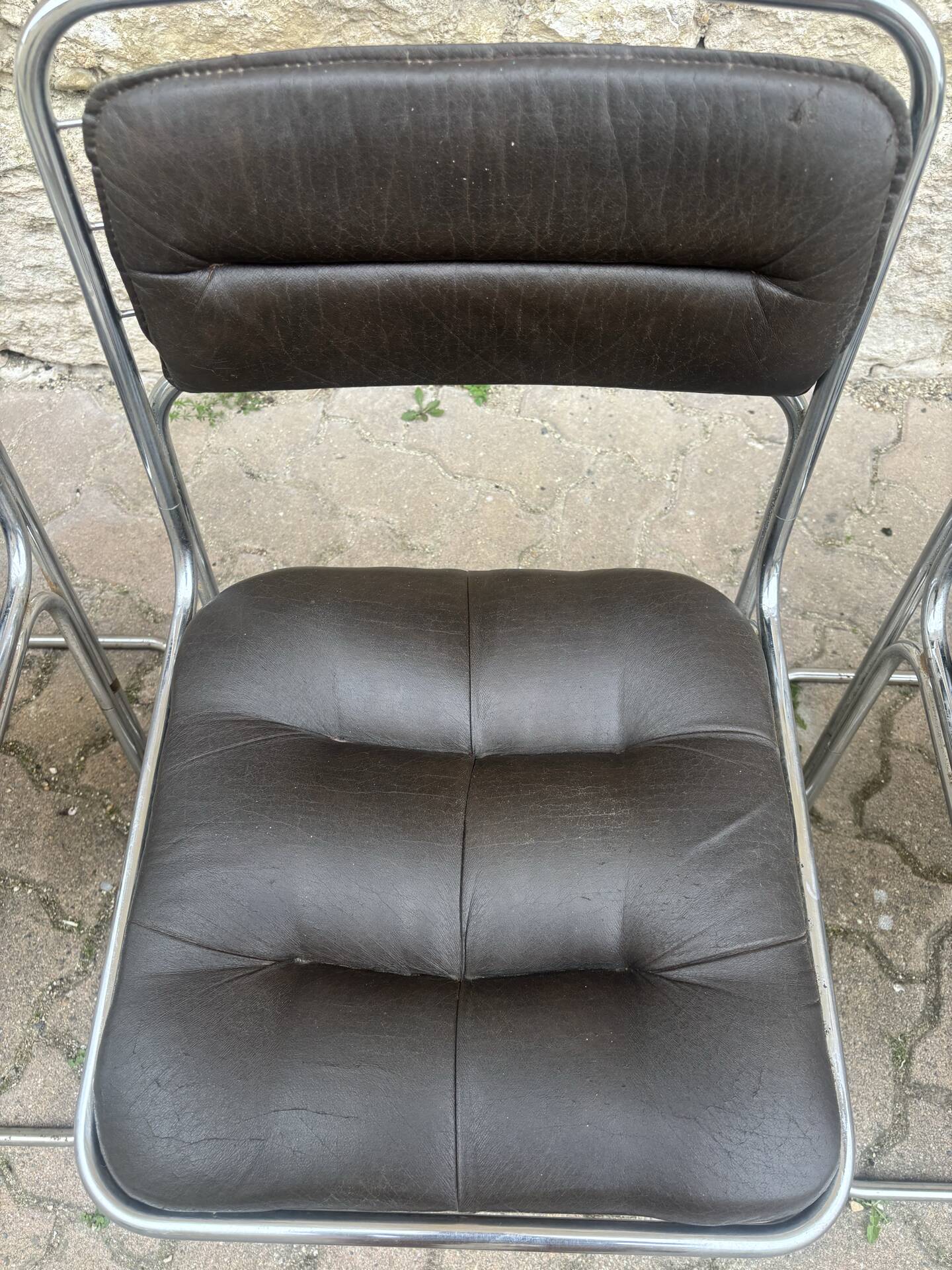Four vintage chairs from the 1960s and 1970s, chrome with faux leather.