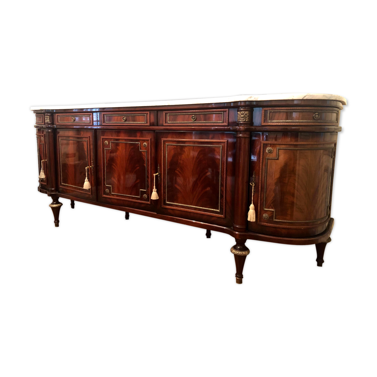 A mahogany buffet varnished with marble and bronze