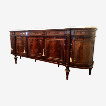 A mahogany buffet varnished with marble and bronze