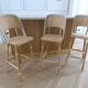 Lot of 3 Maison Louis Drucker light Manila rattan bistro high chairs.