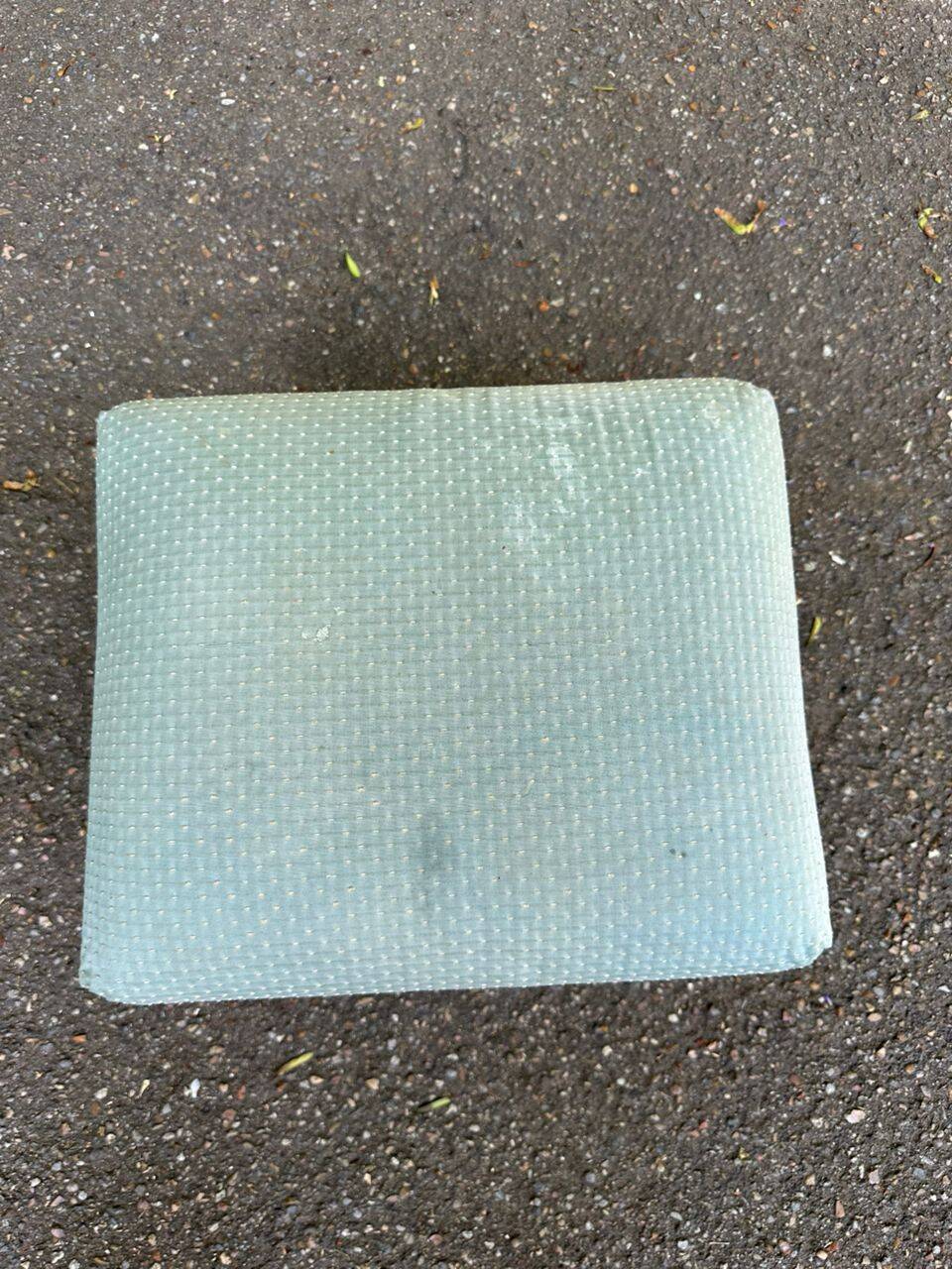 Vintage footstool made of solid wood and blue fabric.