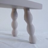 Small vintage wooden bench renovated in pinkish beige