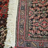 Ancient Persian carpet, wool, red tones, hand-knotted.