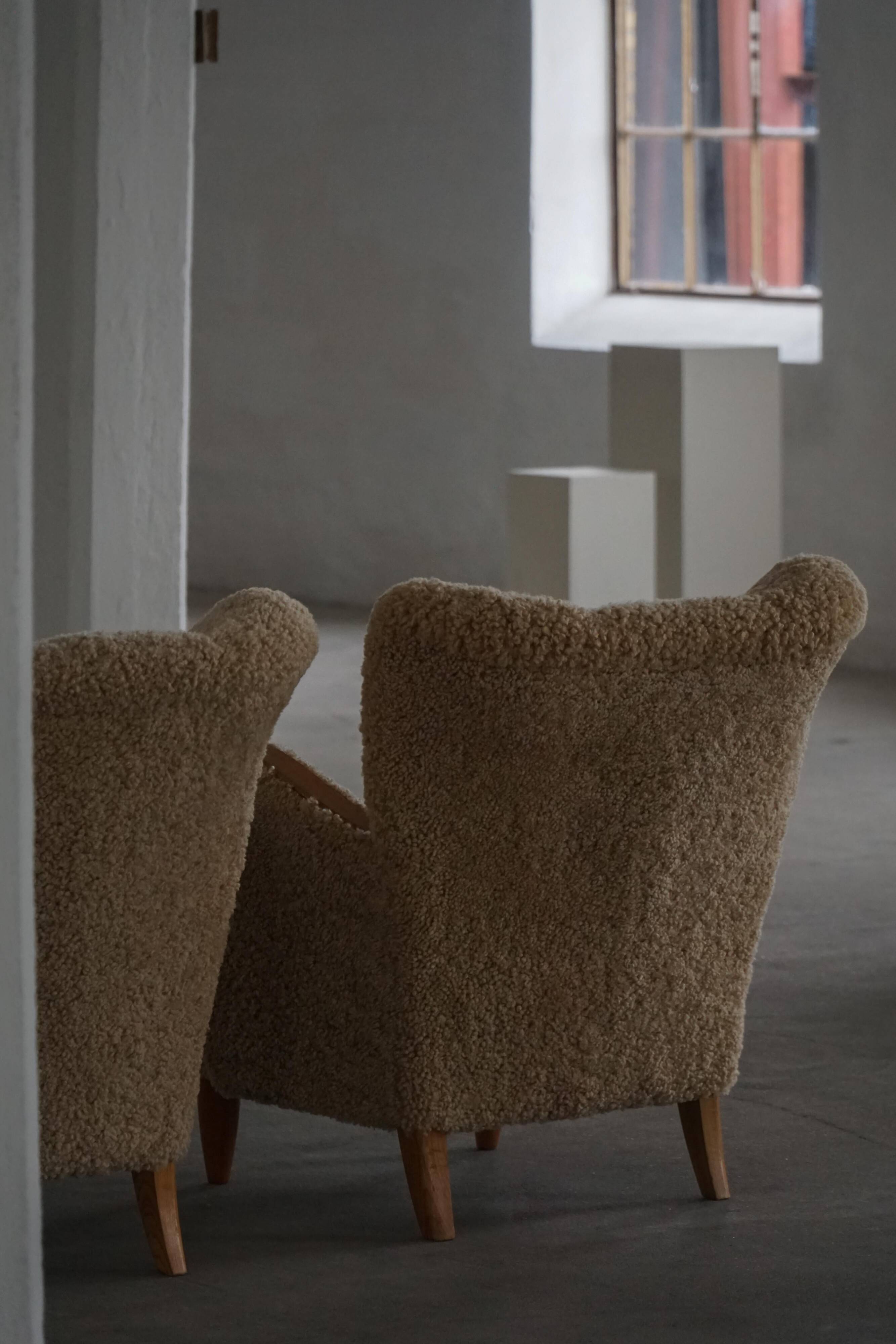 Pair of Danish Art Deco modern lounge chairs in sheepskin with lambswool and elm, 1940s.