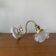 Swan neck wall light in brass with rose petal glass shade.