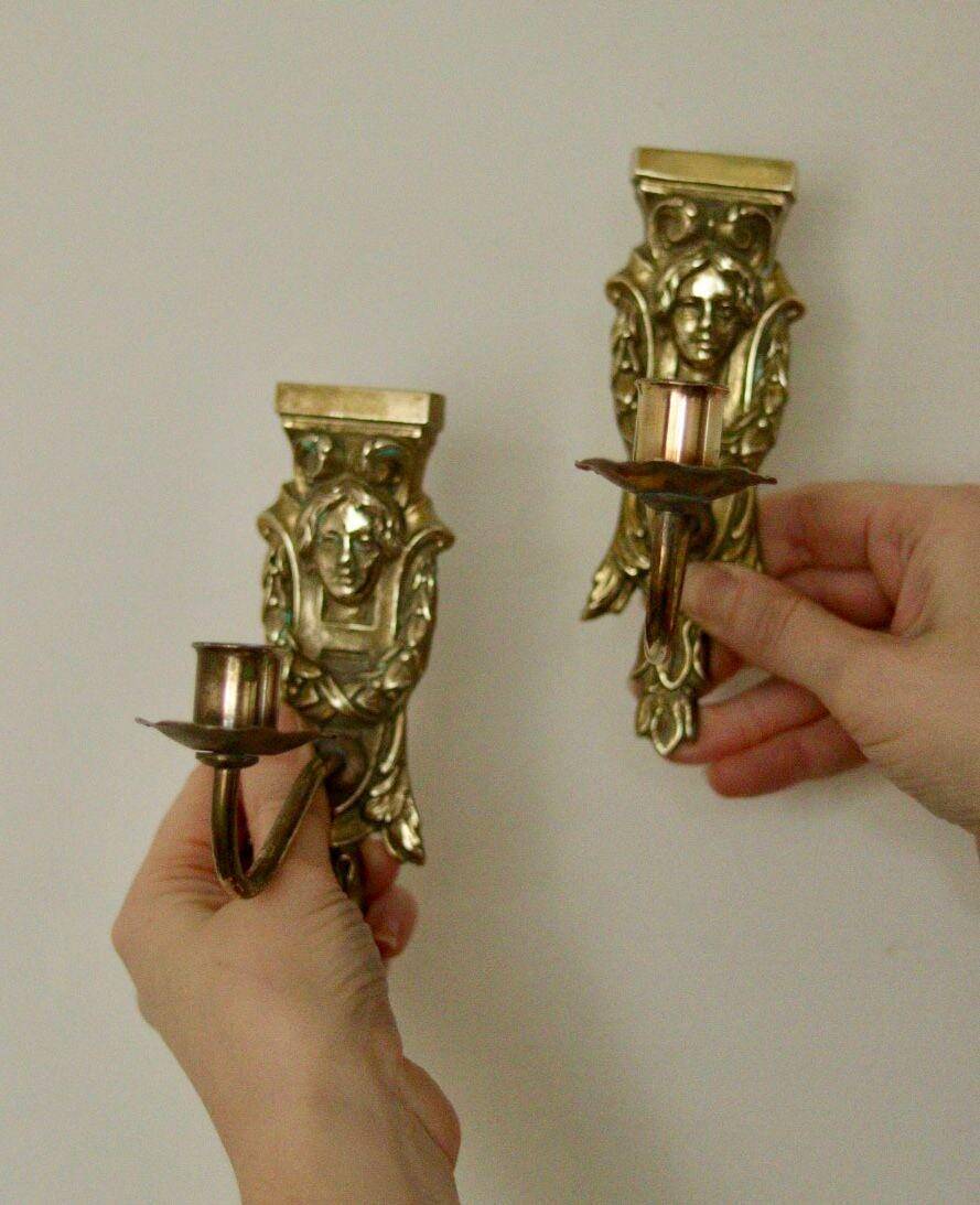 Pair of mid-century Swedish brass face motif sconces