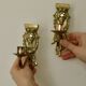 Pair of mid-century Swedish brass face motif sconces