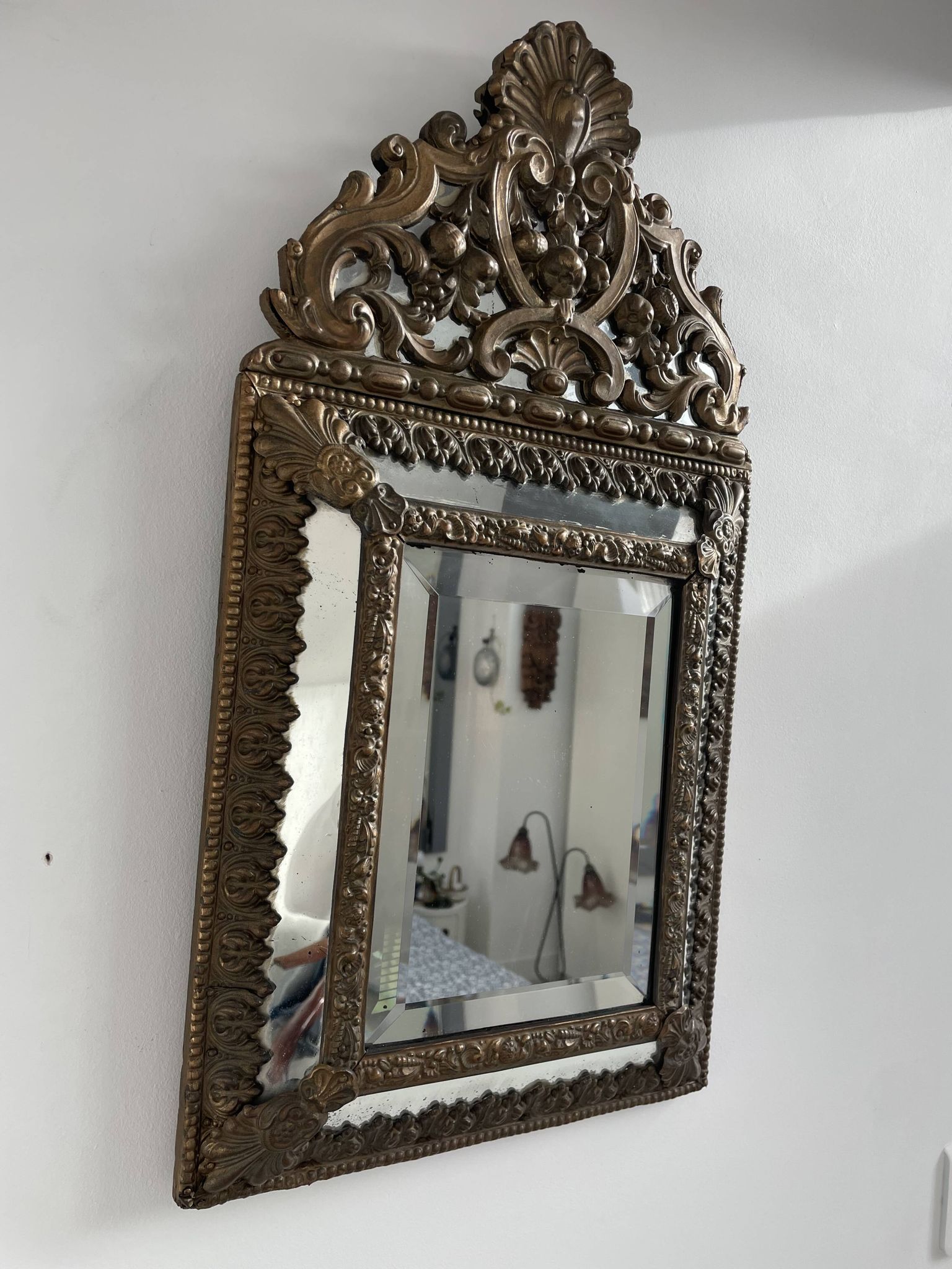 Small mirror with brass parcloses in repoussé style Louis XIV, late 19th century.