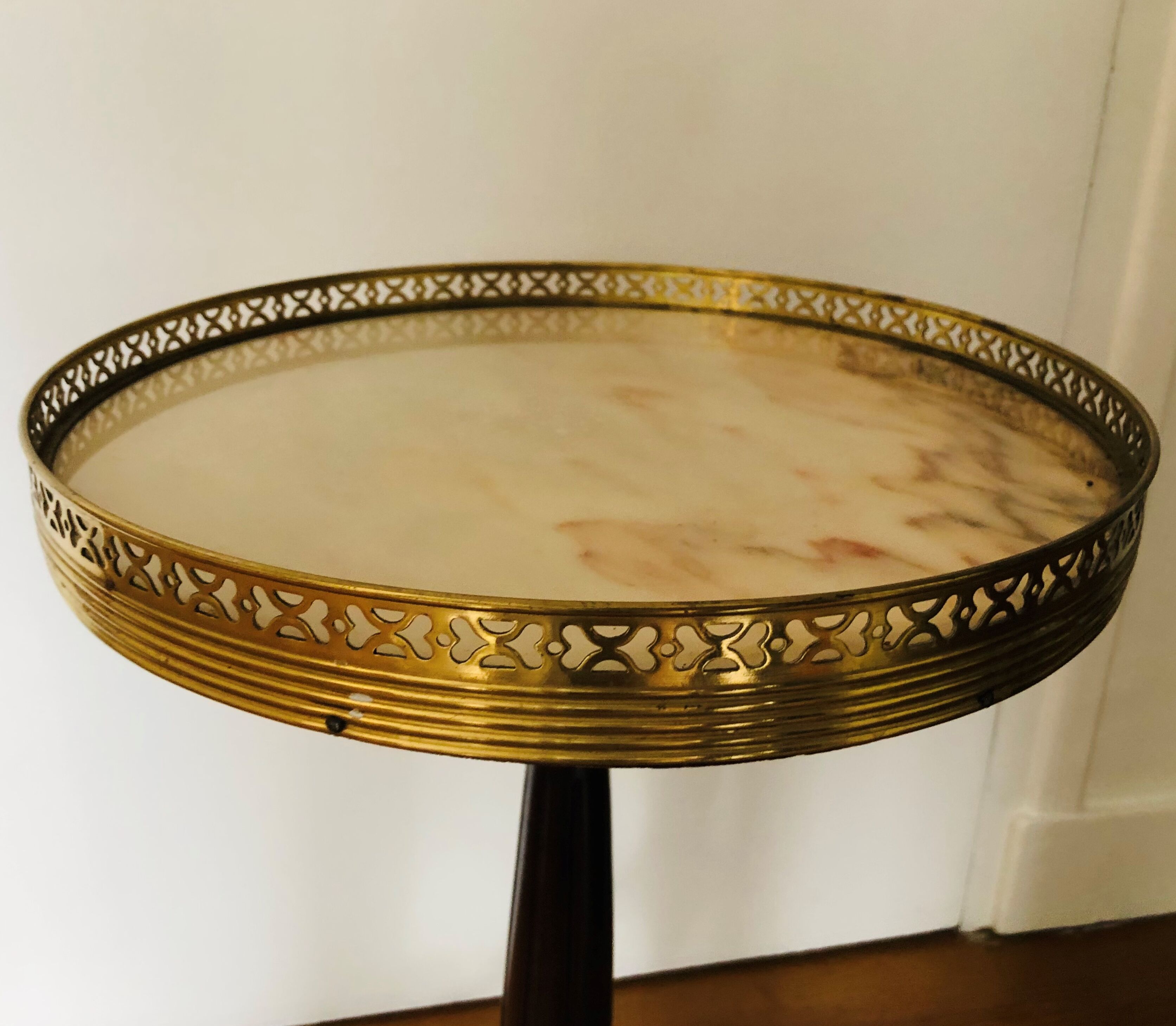 Wooden pedestal table on marble