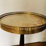 Wooden pedestal table on marble