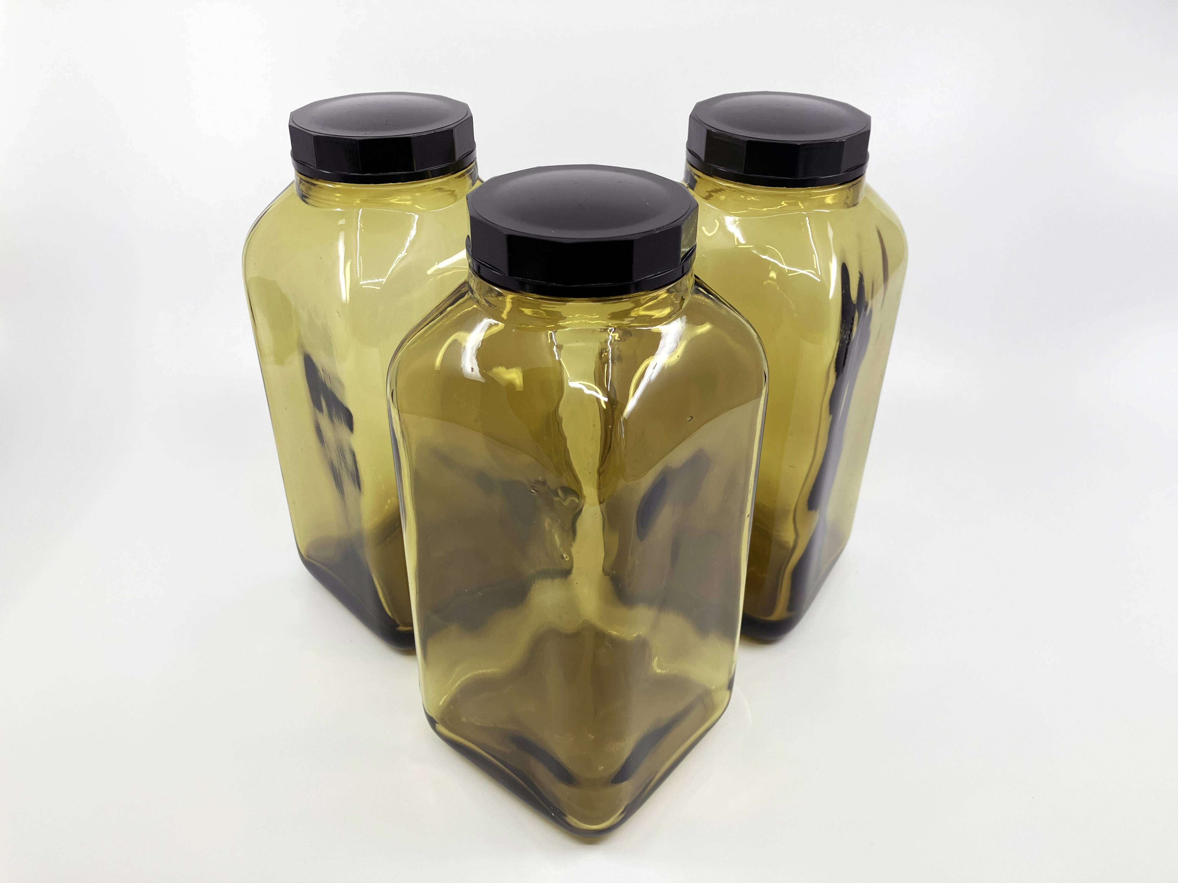 3 molded amber glass pharmacy bottles • Bakelite stoppers • 1950