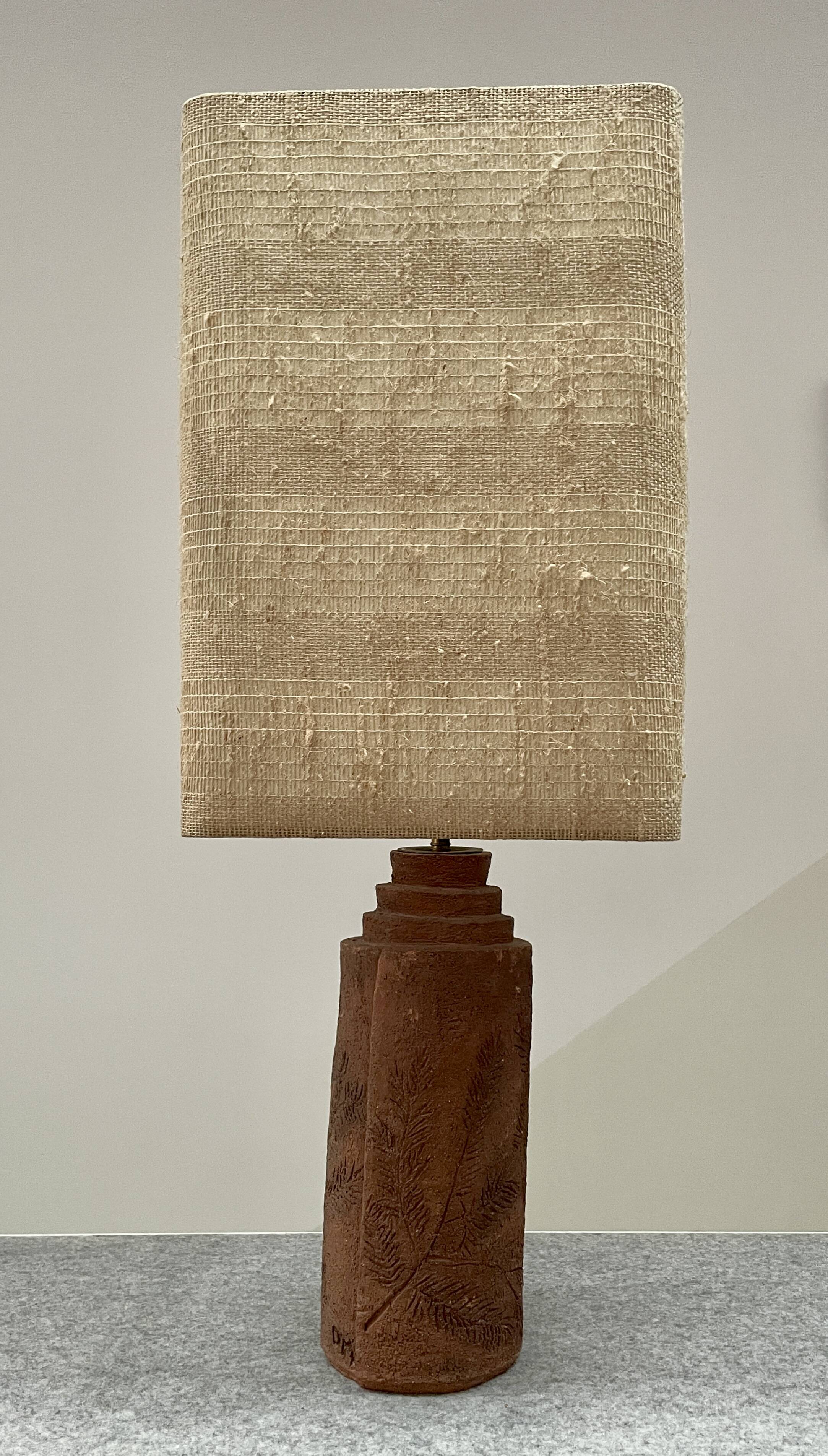 Large chamotte clay lamp in brutalist style, with a plant motif.