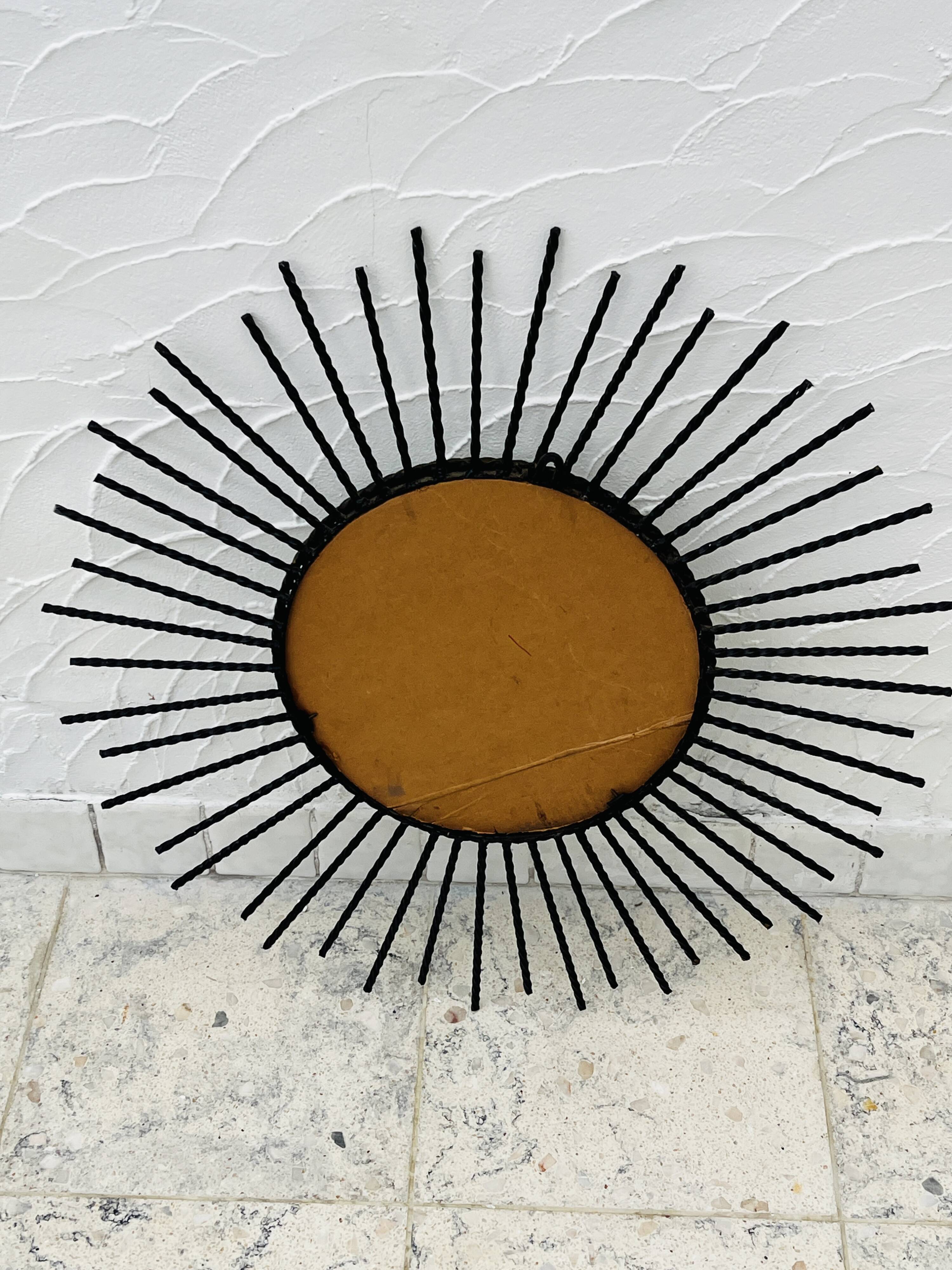 Vintage black and gold metal sun mirror from the 1960s.