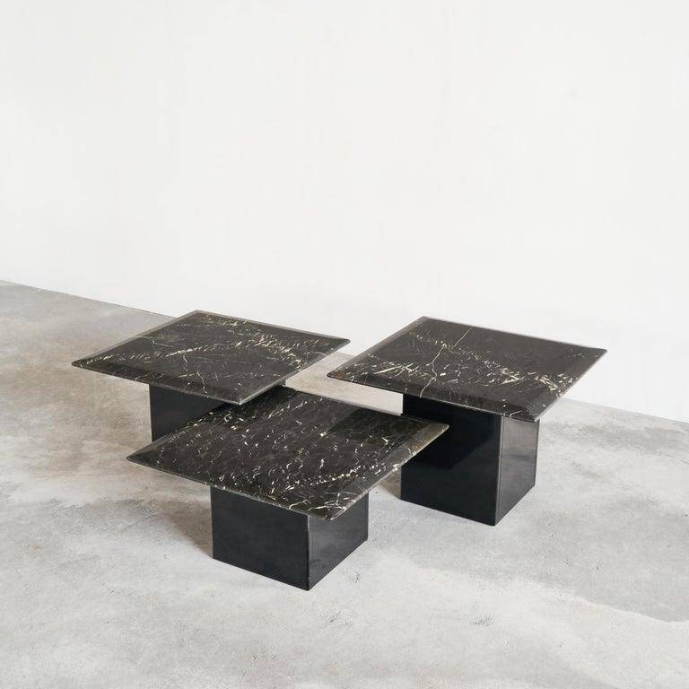 Set of 3 marble and lacquer coffee tables, 1970s.