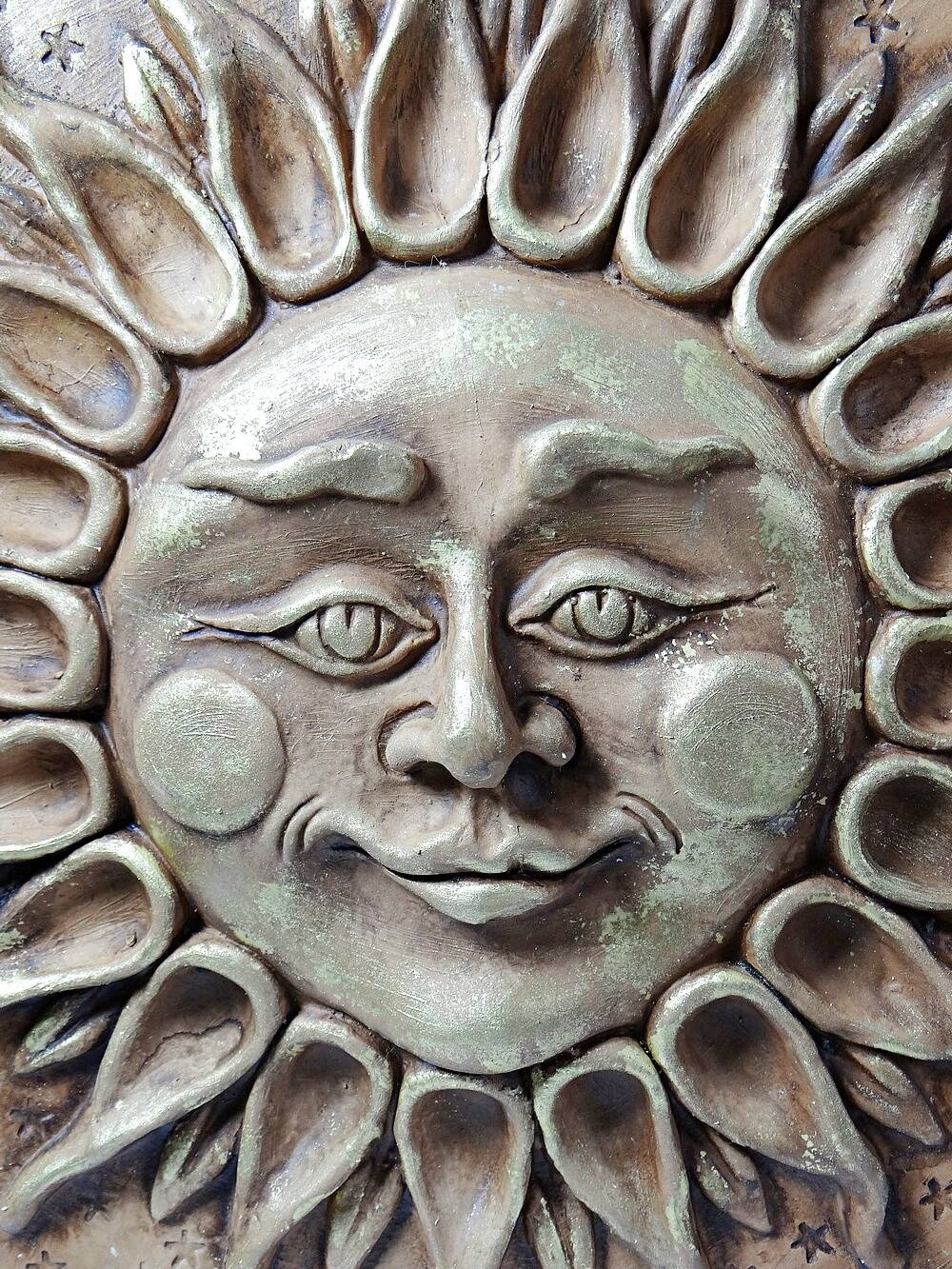Anthropomorphic sun wall sculpture in patinated terracotta, vintage Italian craftsmanship.