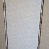 Vintage white faux leather screen with four studded panels, elegant decor.