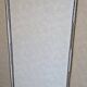 Vintage white faux leather screen with four studded panels, elegant decor.